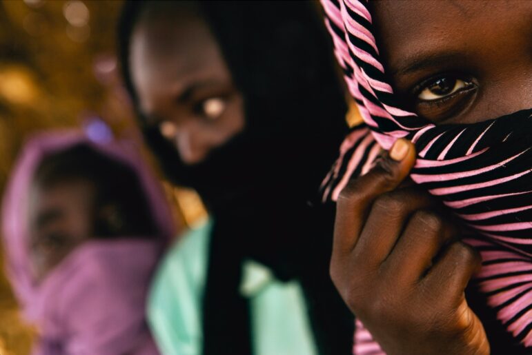 war crimes victims interview Sudanese girls seen in Darfur, Sudan, June 25, 2005. The 12-year-old girl wearing the striped scarf, front, tells how she was separated from her two friends, and raped by soldiers from the Sudanese government.